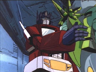 Optimus pats a Quintesson on the side of its head