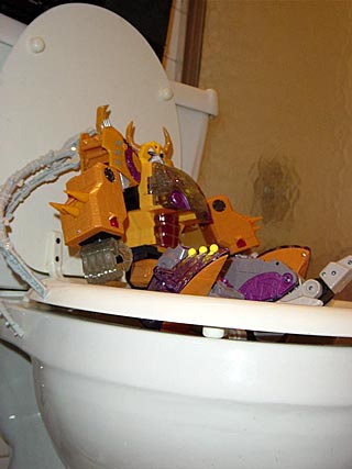 Unicron sitting on a toilet