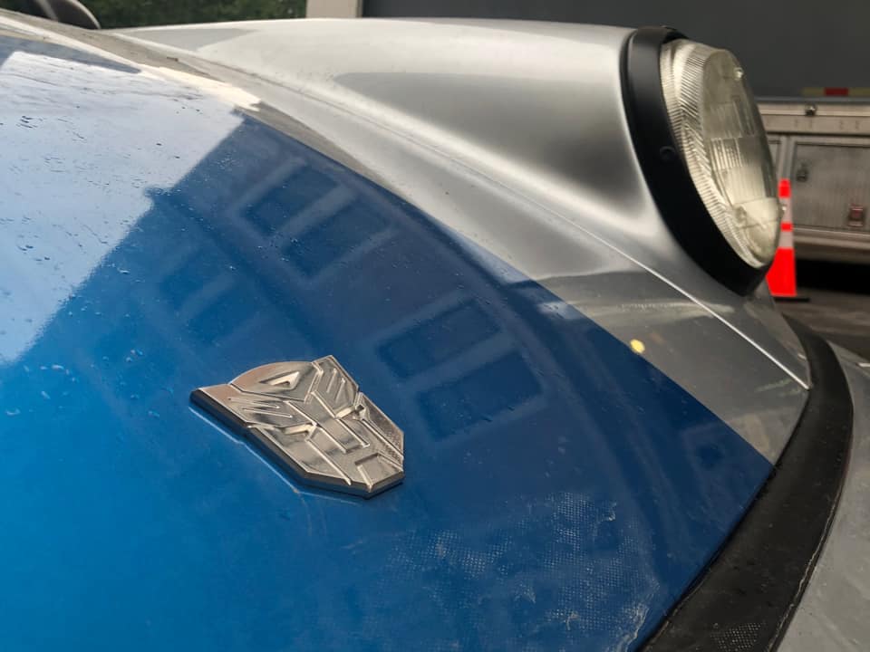 Close Up of Transformers 7 Mirage Shows Autobot Logo Replacing Porsche Badge