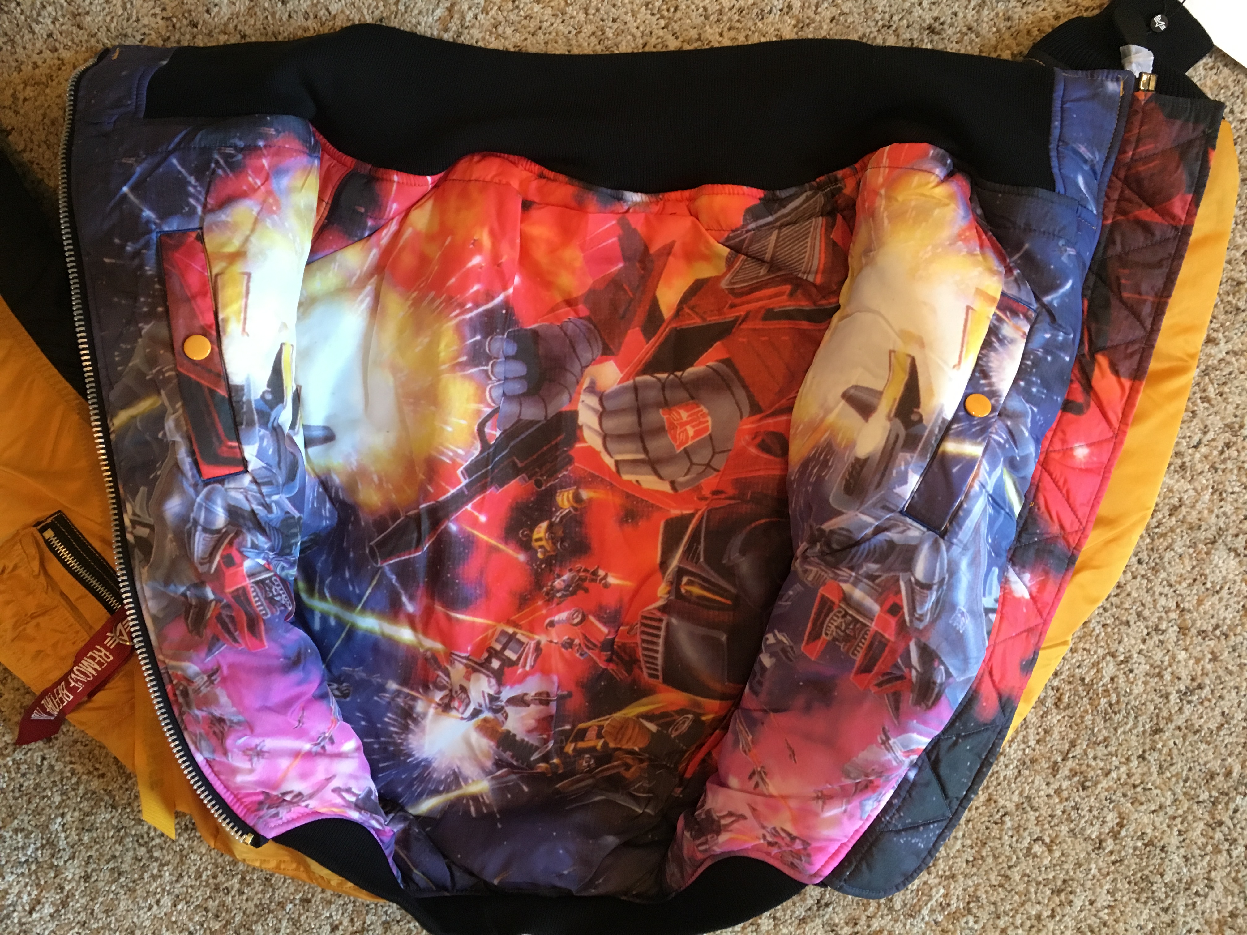 In hand images of Hasbro X Alpha Transformers MA-1 jacket