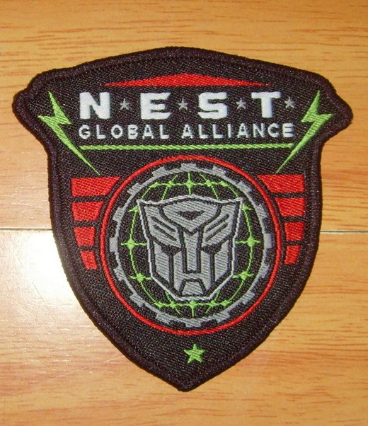 N.E.S.T. Global Alliance Iron On Clothing Patch